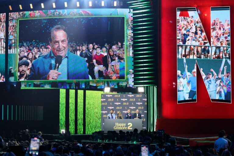 INGLEWOOD, CALIFORNIA - MAY 31: Jon Lovitz speaks with Adam Sandler, Julie Bowen, Christopher McDonald, and Rich Eisen during NETFLIX TUDUM 2025: THE LIVE EVENT at The Kia Forum on May 31, 2025 in Inglewood, California. (Photo by Amy Sussman/Getty Images for Netflix)