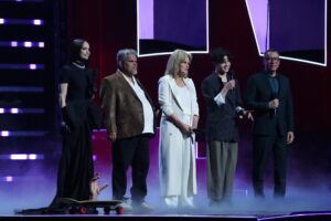 Los Angeles, CA - May 31, 2025: (L-R) Sofia Carson, Thing, Luis Guzman, Joanna Lumley, Isaac Ordonez, Fred Armisen attend NETFLIX TUDUM 2025: THE LIVE EVENT at The Kia Forum in Los Angeles on May 31, 2025. (Photo by KEVIN ESTRADA for Netflix)